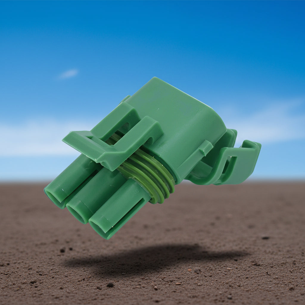 A dark green 3-pin housing kit for a bar map sensor with a keyway, lying on a textured surface.